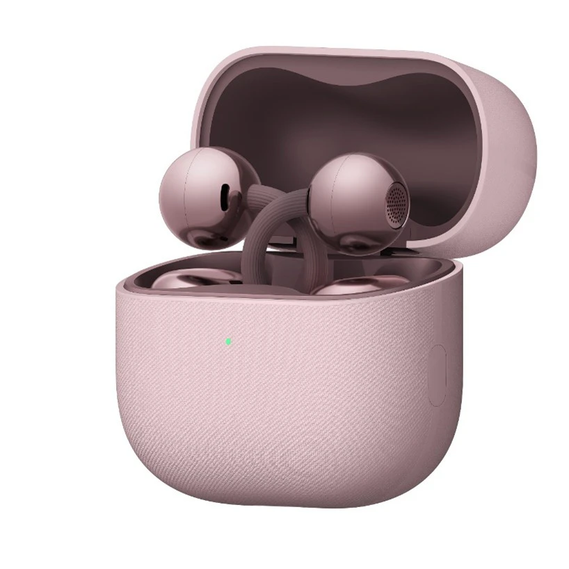Pink true wireless earbuds sitting in an open pink charging case with a green LED indicator on the front