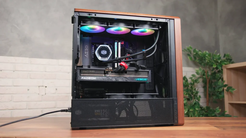 Open mid-tower PC with RGB cooling fans at the top, a liquid CPU cooler, and a Radeon graphics card inside.